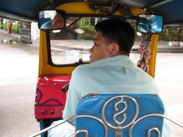 Bangkok'09: Ten pojazd (motocykl przerobiony na rodzaj taksówki) Holendrzy nazywają &quot;tuk-tuk&quot;, co ma chyba jeszcze indonezyjskie korzenie. Sporo sobie takim tuk-tuk'iem pojeździłem po Bangkoku. Oto mój kierowca. Przy odpowiednim podejściu ma się w takim facecie za darmo dobrego przewodnika, który nie tylko wszędzie Cię zawiezie ale i pomoże wybrać co zechcesz, np. krawca gotowego uszyć Ci w 24 godziny elegancki garnitur.